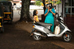 Kochi (Kerala), India: Mother and Young Daughter Chat near Scooter